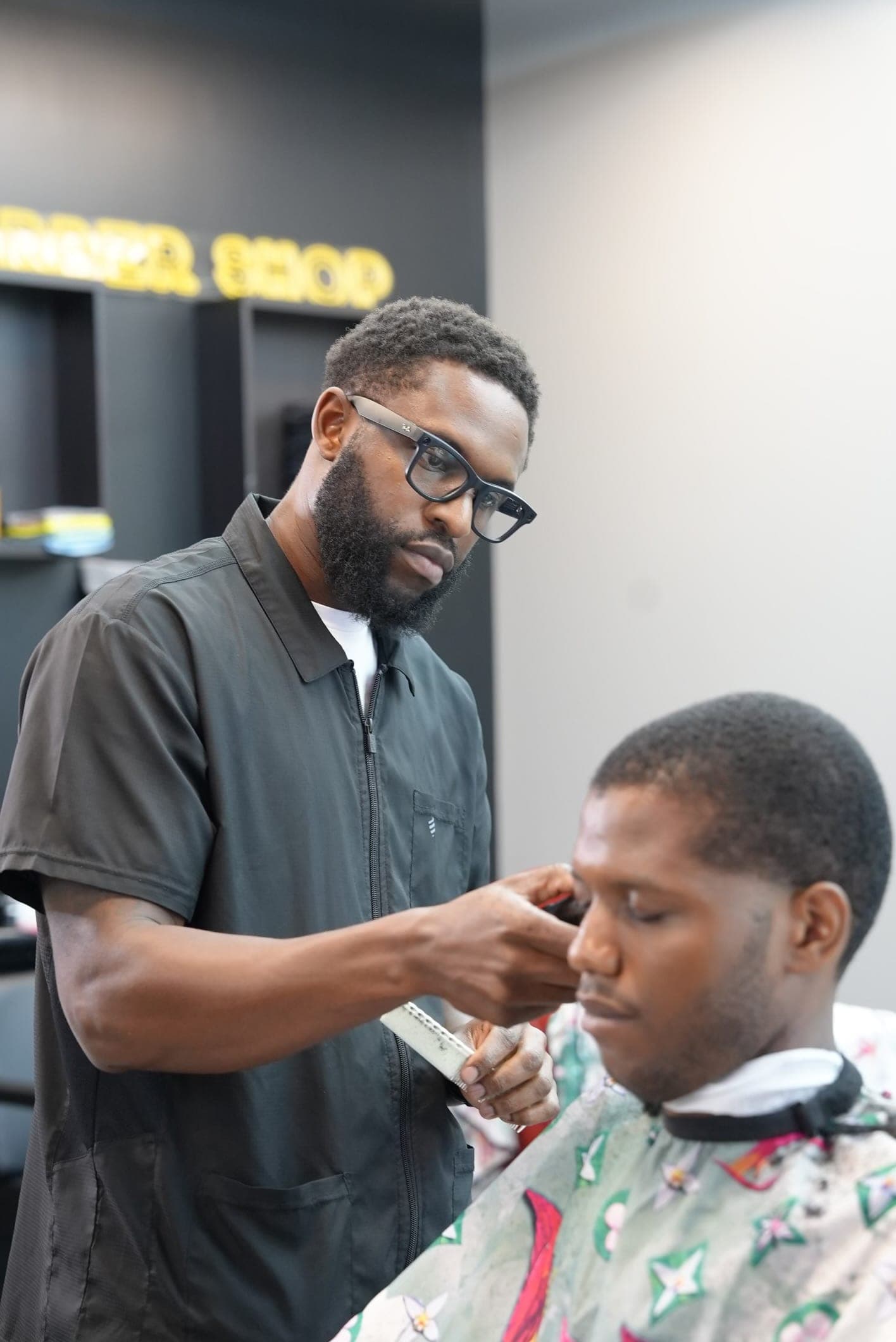 Refining a hairline with comb and trimmer at Barberhood York U