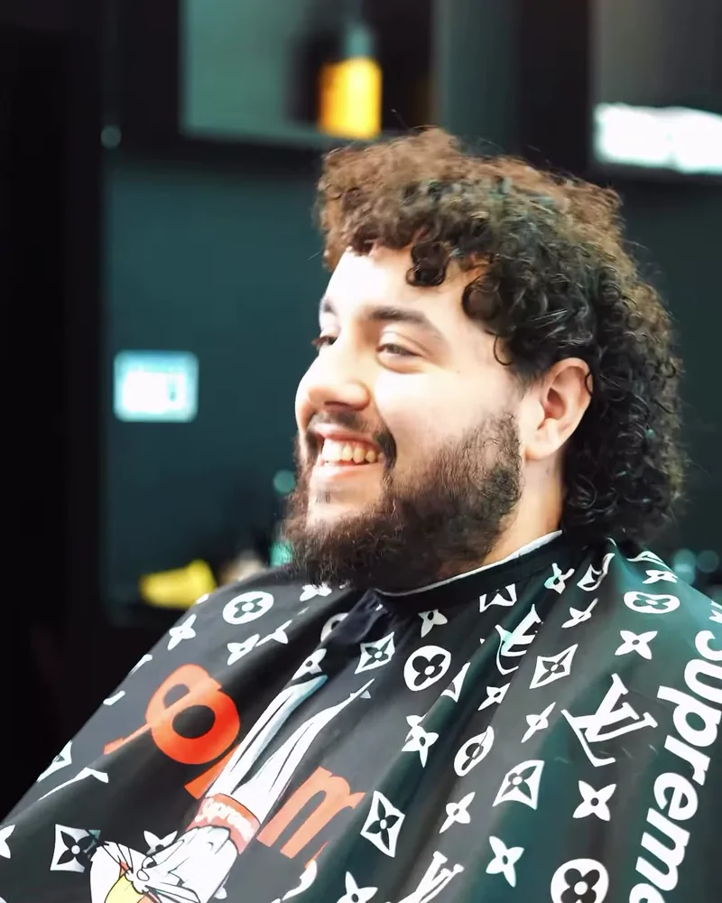 An adult Barberhood York U client smiling after his haircut